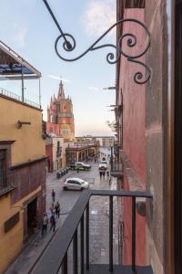 
a city street with buildings and people walking on the sidewalk at Hotel La Morada in San Miguel de Allende
