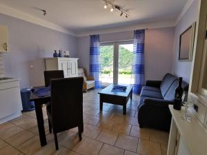 a living room with a couch and a table at Weingut Amlinger&Sohn in Neef