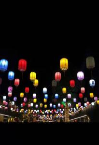 a bunch of lanterns in the sky at night at 7Days Inn Yingshang LAN-STAR building materials market in Fuyang
