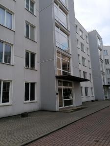an apartment building with a door open on a street at Palm apartment studio Riga in Rīga