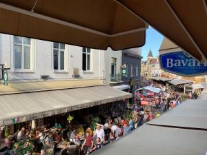 a crowd of people sitting outside of a restaurant at Le Bistro in Valkenburg
