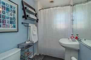 a bathroom with a sink and a toilet and a shower at Across from Dollywood w FREE Dollywood ticket, pets ok wfee, arcade, hot tub in Pigeon Forge +20 photos