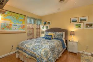 a bedroom with a bed and a map on the wall at Across from Dollywood w FREE Dollywood ticket, pets ok wfee, arcade, hot tub in Pigeon Forge