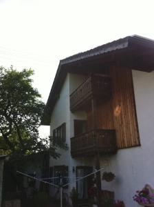 a house with wooden balconies on the side of it at Zugspitzhome Appartment in Farchant