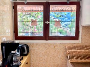 a window in a kitchen with a coffee maker at Villa Astraea Kyra Panagia in Kyra Panagia