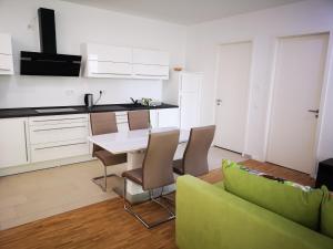 a kitchen and dining room with a table and chairs at Apartment near fair and central City in few min, with garden in Frankfurt/Main