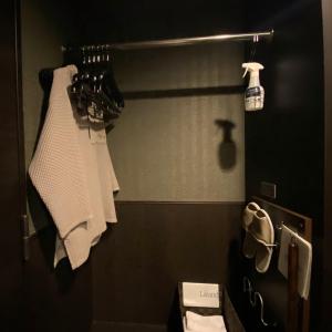 a bathroom with white towels hanging from a rack at Dormy Inn Premium Kyoto Ekimae Natural Hot Spring in Kyoto