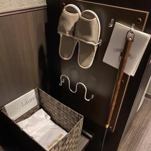 a basket with towels in a room with a wall at Dormy Inn Premium Kyoto Ekimae Natural Hot Spring in Kyoto