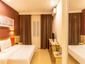 a hotel room with a large bed and a desk at 7Days Inn Suzhou Park New Area Commercial Street in Suzhou
