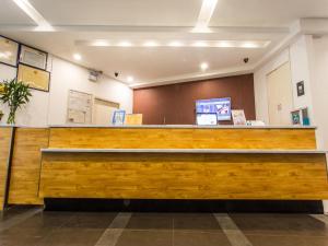 a lobby with a wooden counter in a building at 7Days Inn Suzhou Park New Area Commercial Street in Suzhou