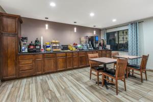 a restaurant with two tables and a counter at Days Inn by Wyndham Waco in Waco