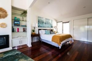 a bedroom with a bed and a tv in it at Araluen Boutique Accommodation in Yarra Glen