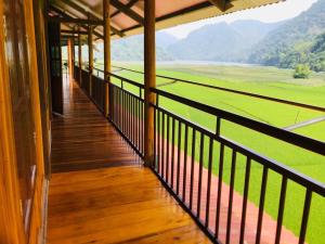 a balcony with a view of a green field at Trần Thực homestay-Ba bể in Ba Be18