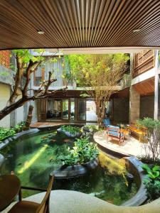 a large koi pond in the middle of a building at Minh Boutique in Danang