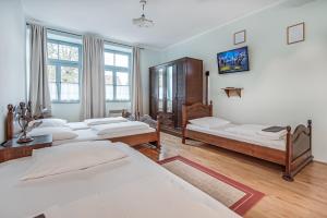 Postel nebo postele na pokoji v ubytování Parma Guesthouse & Apartments