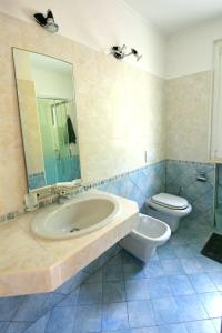 a bathroom with a sink and a toilet at Villa Oliveto apartments in Oliveto Lario