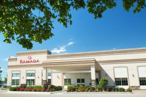 a ramada building with a sign on it at Ramada by Wyndham Trenton in Trenton