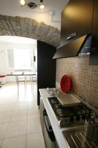 a kitchen with a stove and a counter top at Villa Oliveto apartments in Oliveto Lario