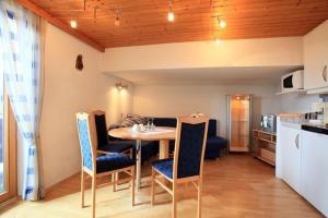 a kitchen and dining room with a table and chairs at Neukumhof in Westendorf