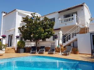 a villa with a swimming pool and a house at Casa Pani in Empuriabrava