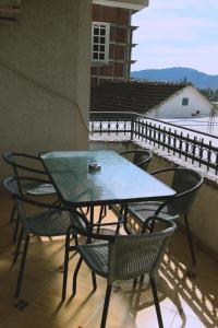 a table and chairs on a balcony with a view at Apartments Vila Monegro in Bar