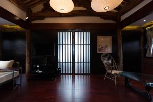 a living room with a table and a chair at Dali Sky Valley Heritage Boutique Hotel in Dali