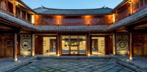 an exterior view of a building with glass doors at Dali Sky Valley Heritage Boutique Hotel in Dali