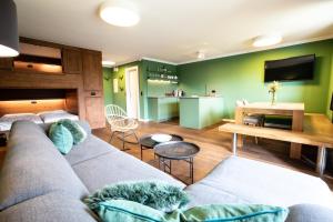 a living room with a couch and a tv at Haus Wiesberger Apartment TOP25 Südseite in Königsleiten