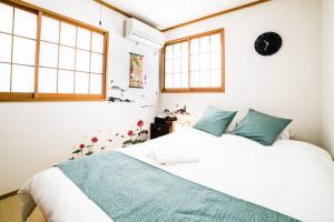 Giường trong phòng chung tại アンドステイ西早稲田3丁目