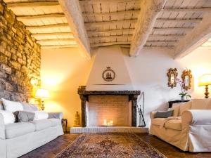a living room with a fireplace with two couches at Tenuta Cortedomina in Radda in Chianti