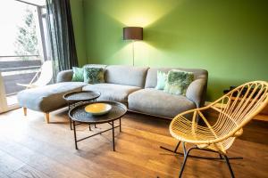 a living room with a couch and two chairs at Haus Wiesberger Apartment TOP25 Südseite in Königsleiten
