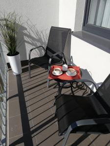 a table with a plate of food on a balcony at Apartament NA KLIFIE in Słupsk