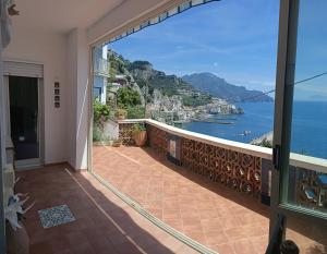 a balcony with a view of the ocean at Bouganville & Sea in Amalfi +7 photos