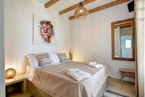 a bedroom with a bed with two towels on it at Punda Villas Paros in Kampos Paros