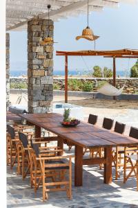 a wooden table and chairs on a patio at Punda Villas Paros in Kampos Paros