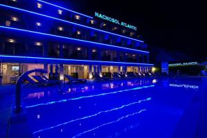 a swimming pool in front of a building at night at IG Nachosol Atlantic & Yaizasol by Servatur - Adults Only in Puerto Rico de Gran Canaria