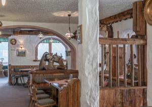 a living room with a table and a dining room with a tableablish at Alpengasthof Gaislach Alm in Sölden