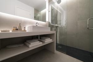 a white bathroom with a sink and a shower at JB Luxury Suites in Nafplio +34 photos