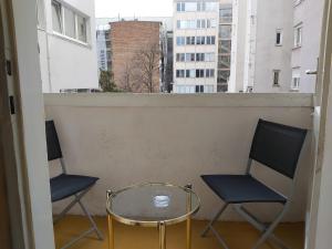 two chairs and a glass table on a balcony at Apartment Croatia in Zagreb