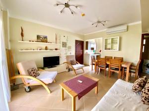 a living room with a couch and a dining room at Cozy Family 3 BR apartment by the sea in Marsa Alam City