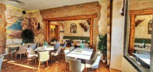 a restaurant with tables and chairs in a room at Casa Crown in Braşov