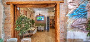 a dining room with tables and chairs and a wall at Casa Crown in Braşov