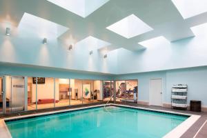 a swimming pool in a building with a large ceiling at The Stamford Hotel in Stamford