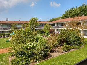 an exterior view of a building with a garden at KLAPROOS Bed by the Sea in Westkapelle