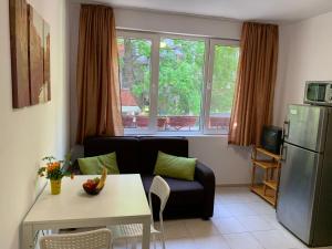 a living room with a couch and a table at Samuil Apartments - Central Burgas in Burgas