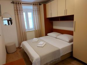 a bedroom with a bed with two towels on it at Guest House Korunić in Korčula +17 photos