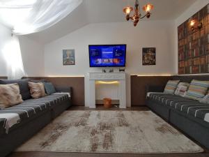 a living room with two couches and a fireplace at Apartment 15 in Borovets