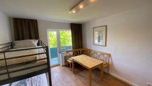 a bedroom with a table and a bunk bed at Bs Living Apartment in Braunschweig