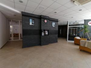 a lobby with a black wall with a clock in it at Apartment 15 in Borovets