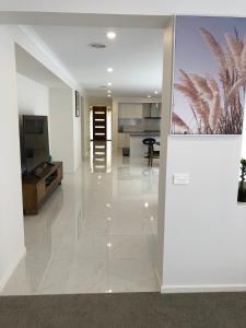 a living room with white walls and a white tile floor at Apple House Upper Point Cook in Point Cook